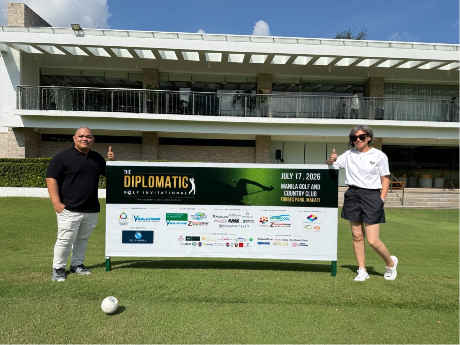 AVC team beside the tournament sponsor board