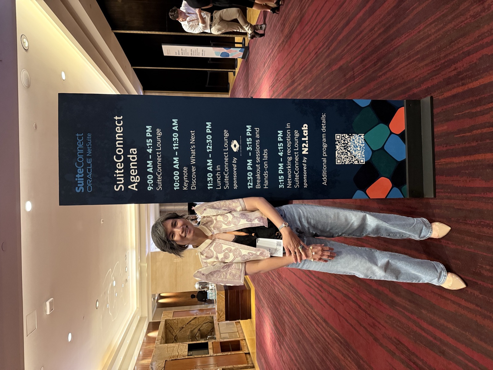 AVC's Novel Espina beside the SuiteConnect agenda board